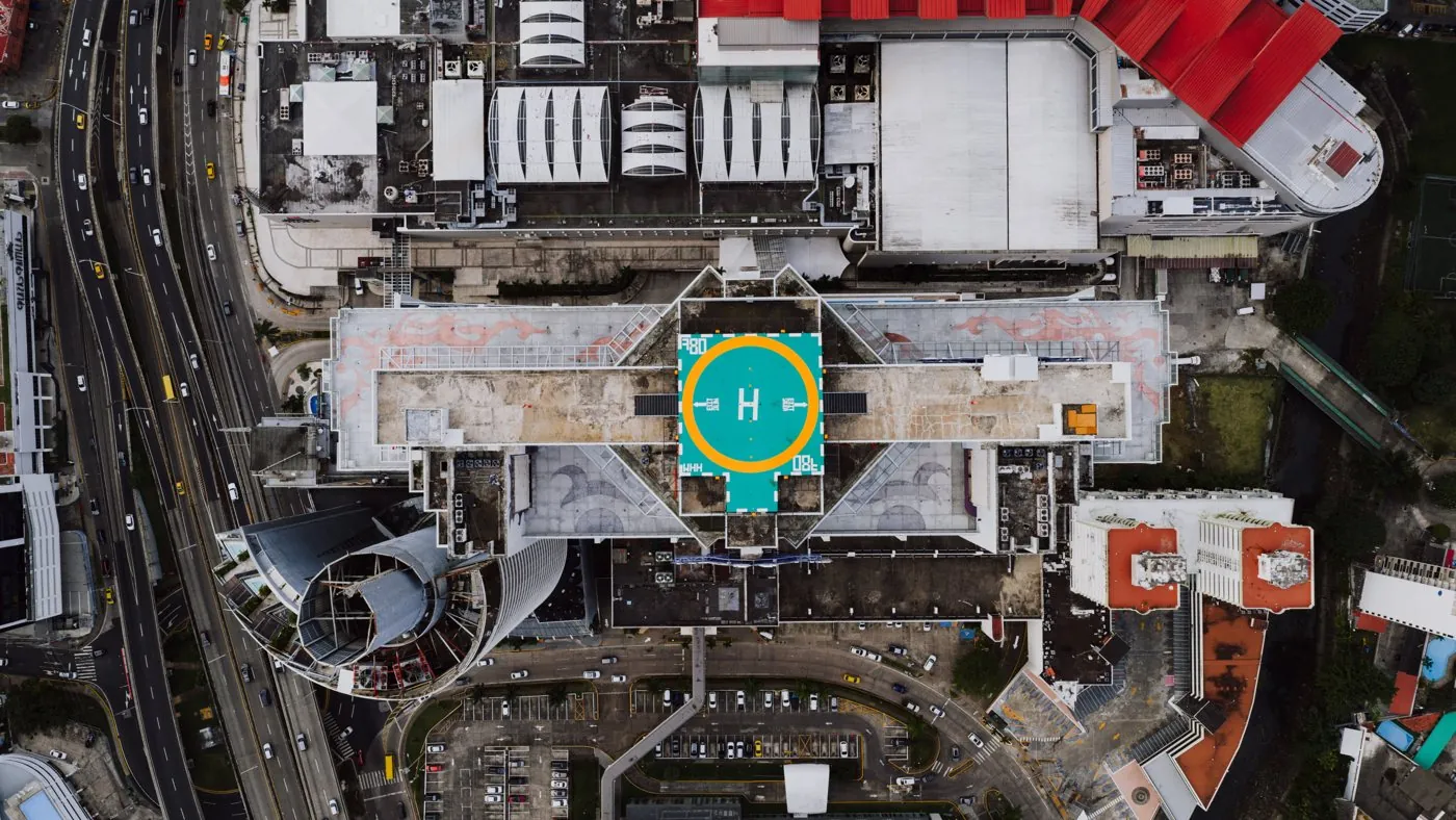 Health planning: an aerial view of a hospital with a rooftop helipad